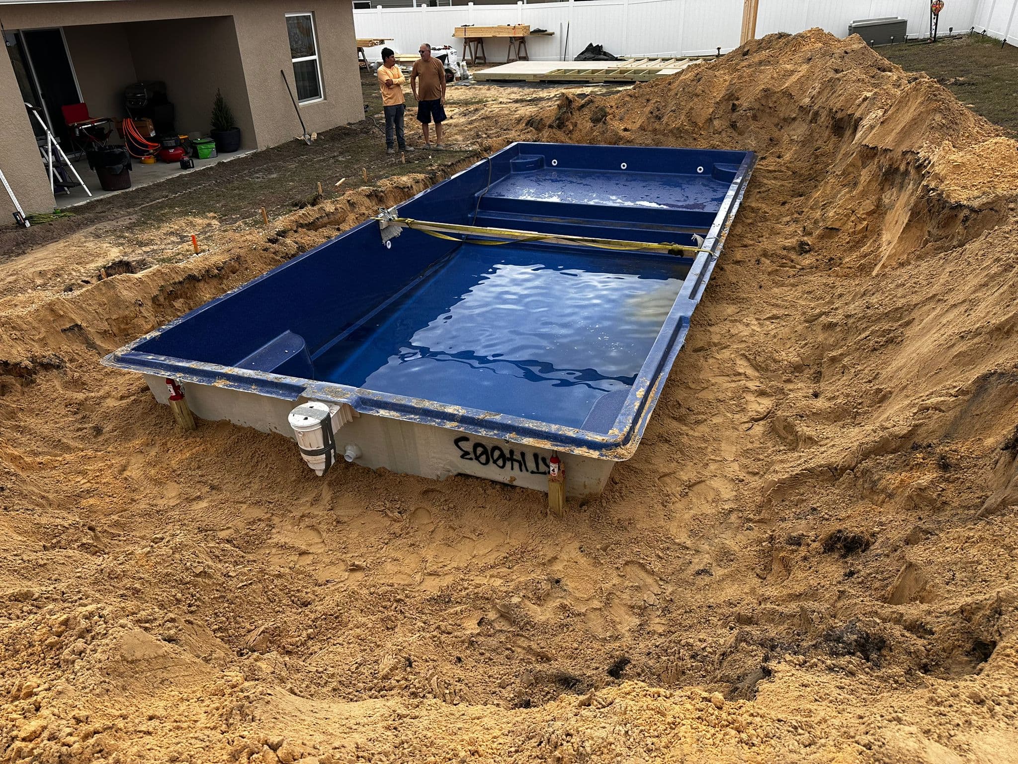 Professional pool installers near me in Florida - Cool Pool Florida certified installation team setting fiberglass pool shell with crane equipment