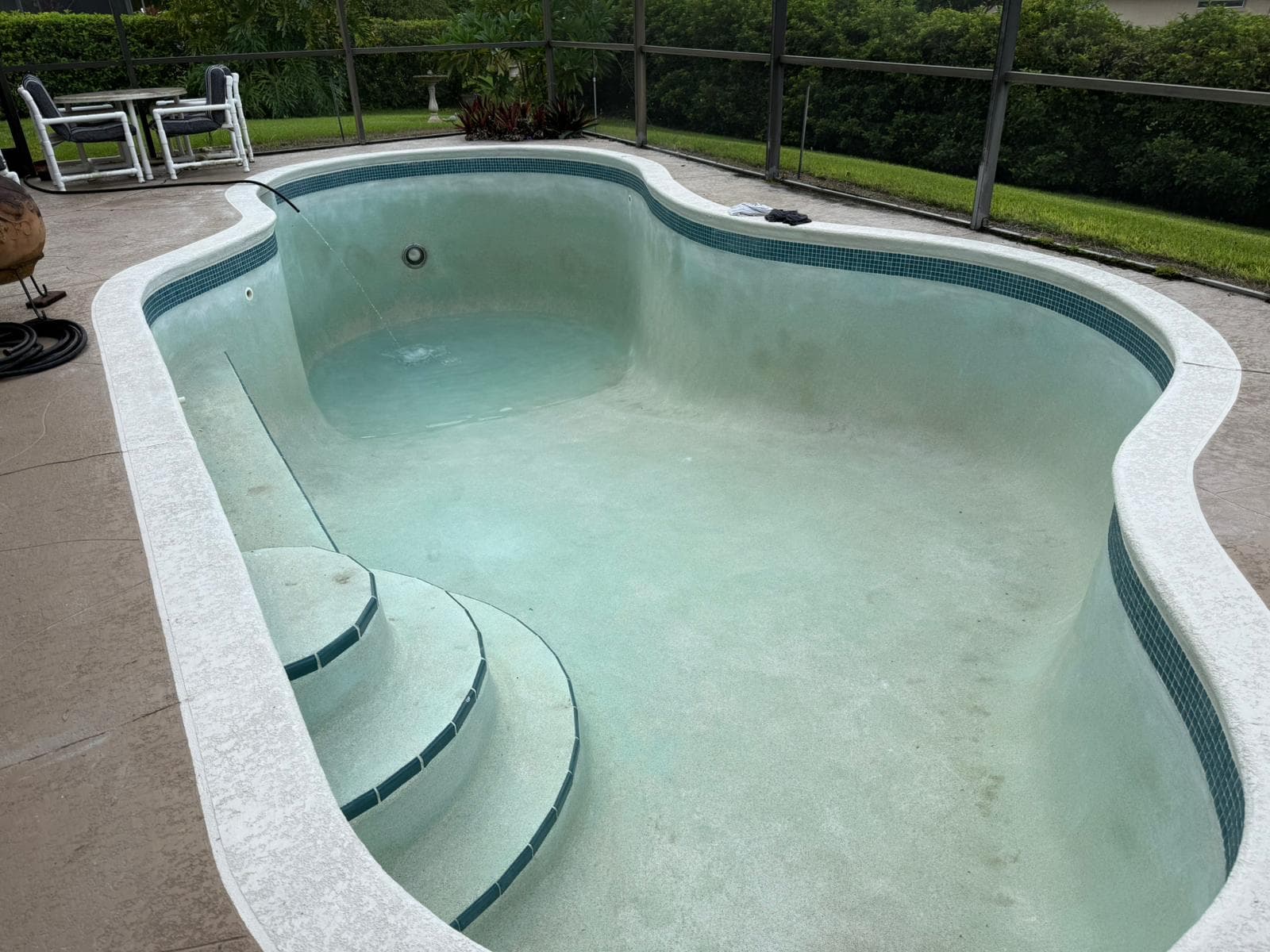 Beautiful mosaic tile waterline installation with curved pool design
