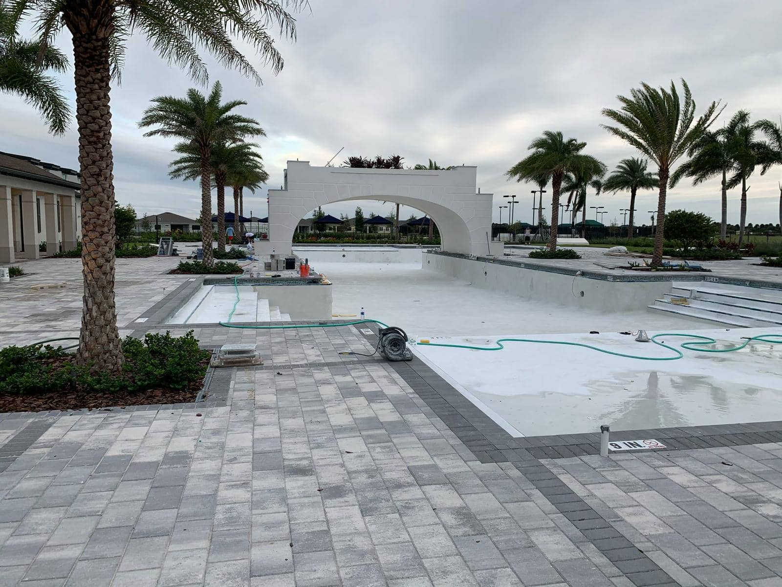Commercial pool after resurfacing - beautiful finished commercial pool complex with pristine white surface and architectural bridge