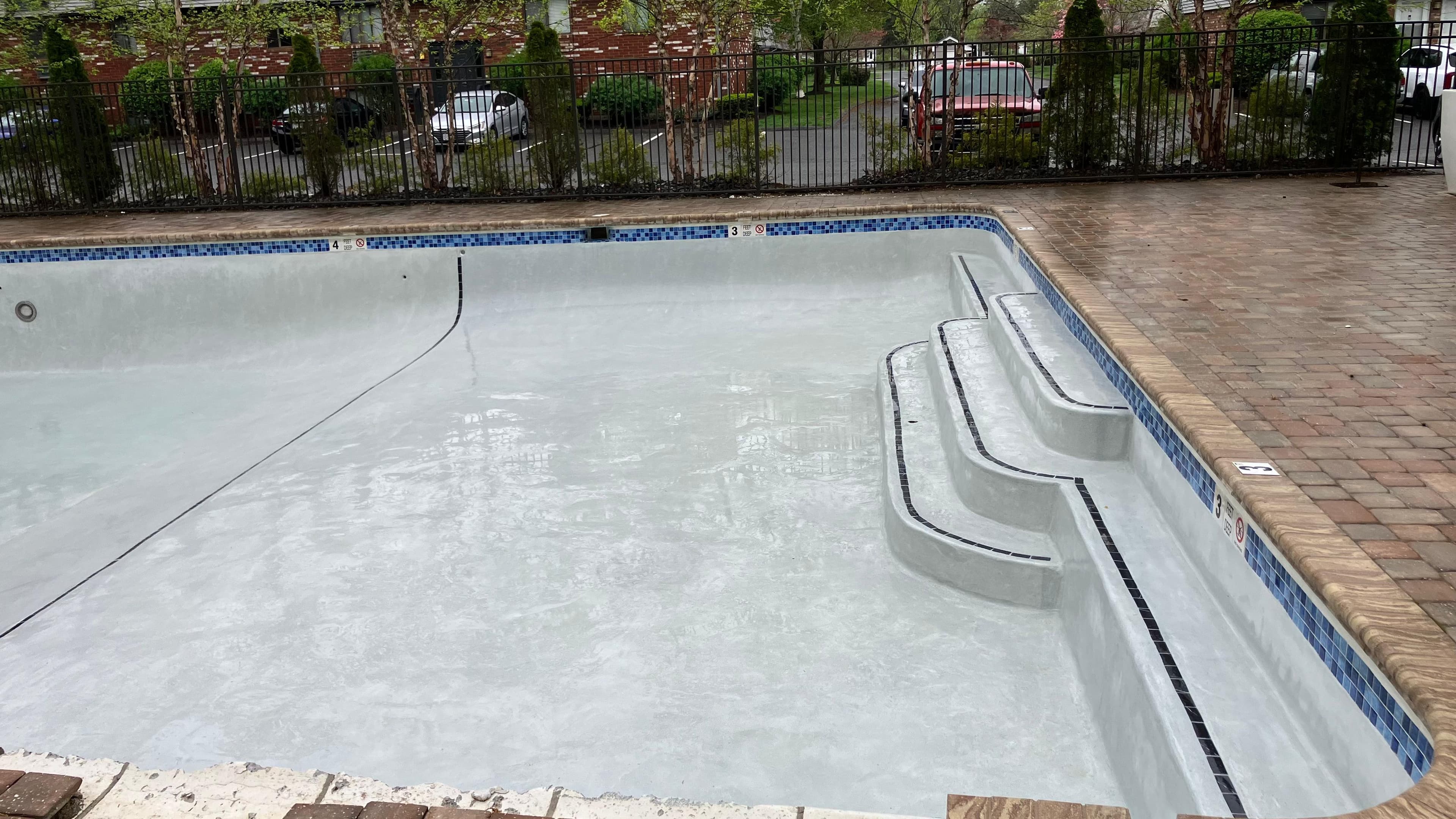 Pool after resurfacing - wide angle view showing complete pool restoration