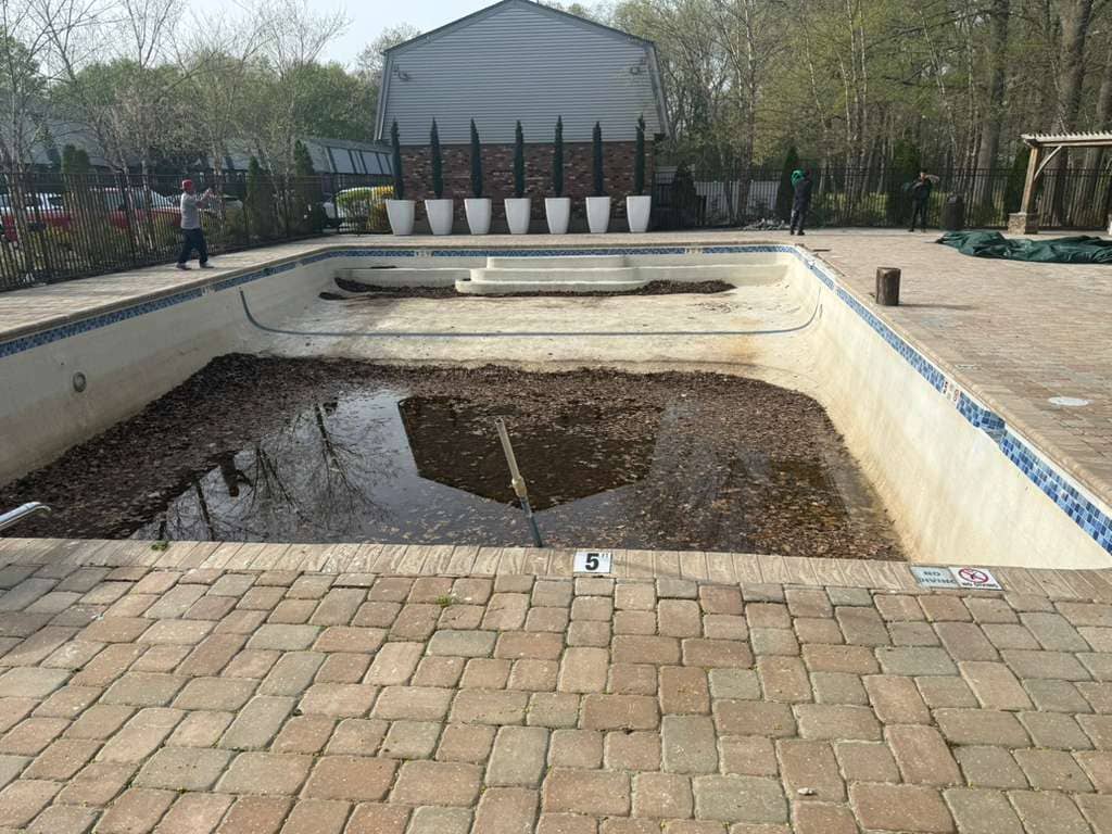 Damaged concrete pool surface before resurfacing