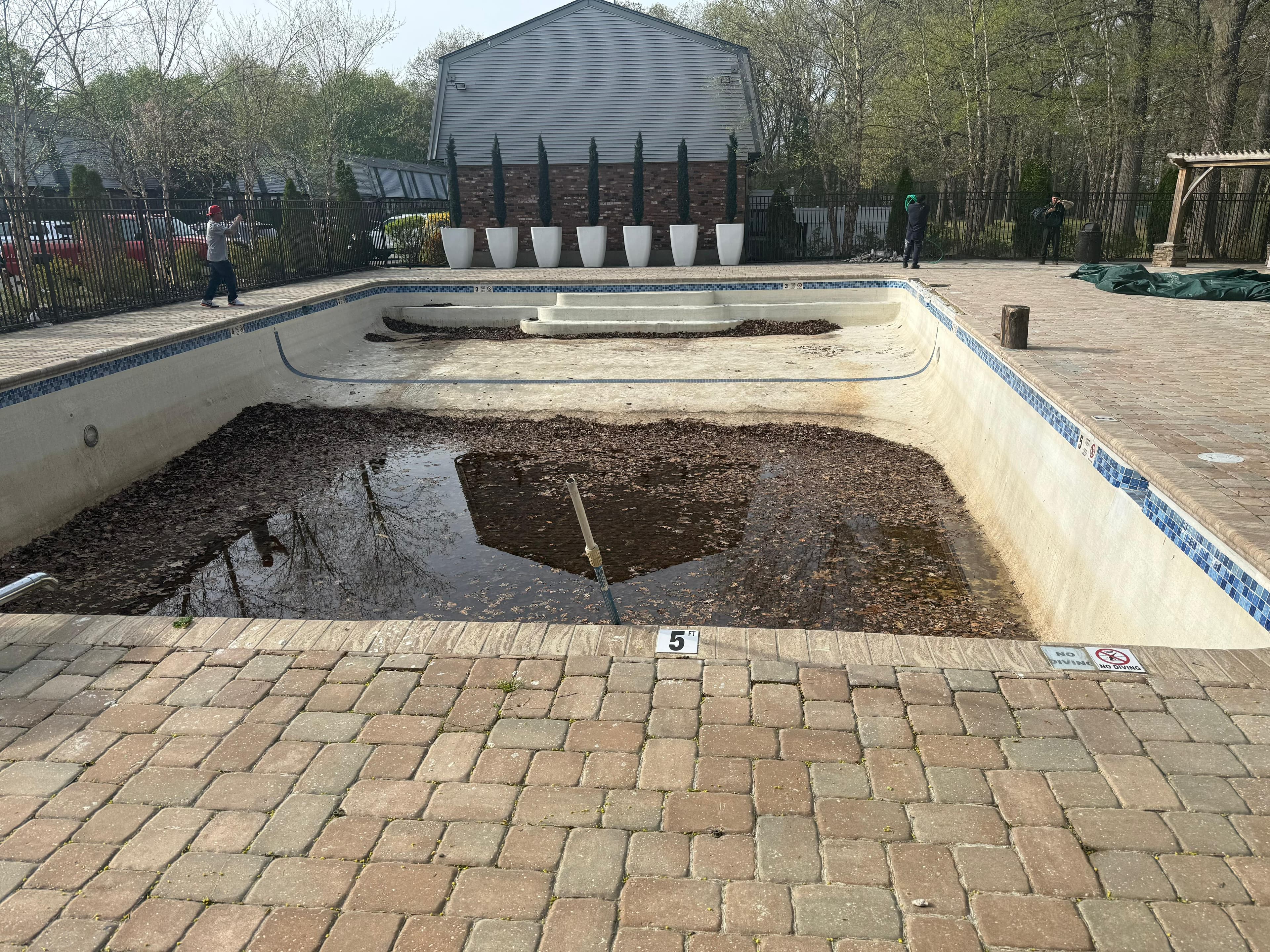 Pool before resurfacing - showing extent of surface damage and preparation needed