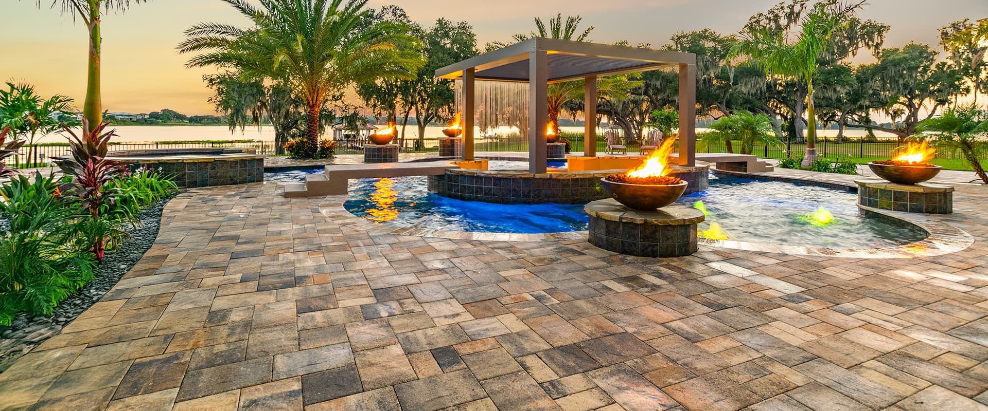 Beautiful brick paver pool deck surrounding a swimming pool